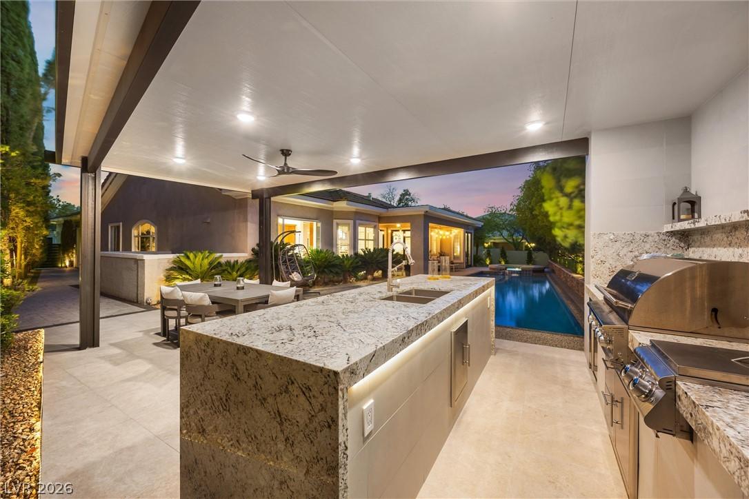 Image 3: An inviting outdoor kitchen and dining area provid