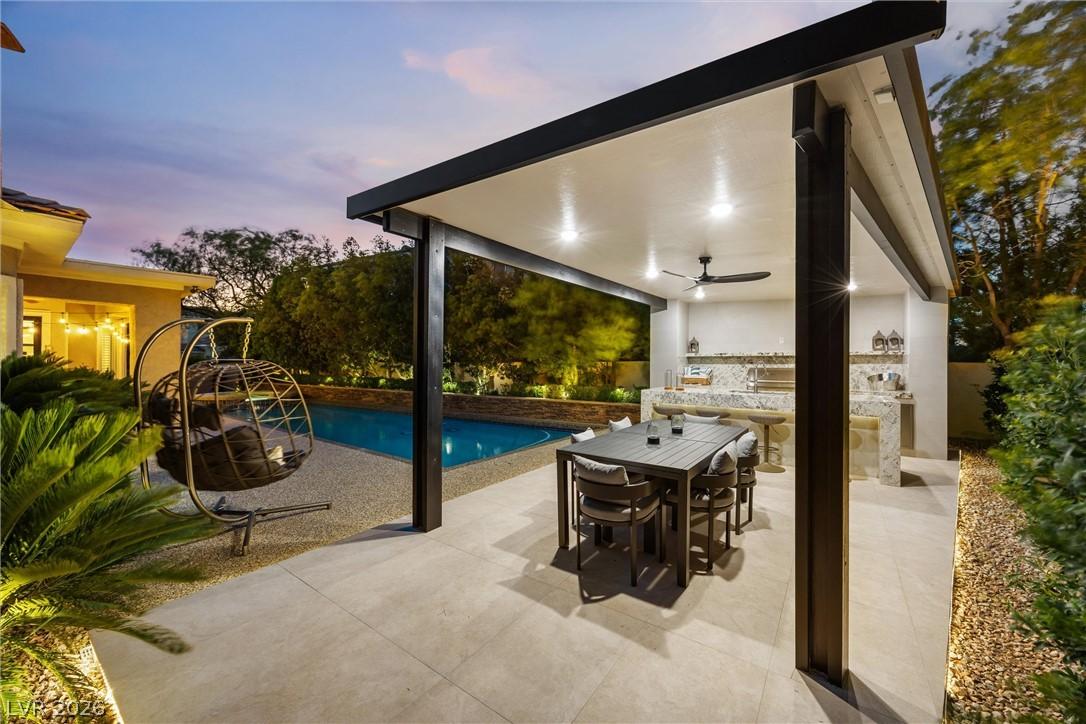 Image 4: An inviting outdoor kitchen and dining area provid