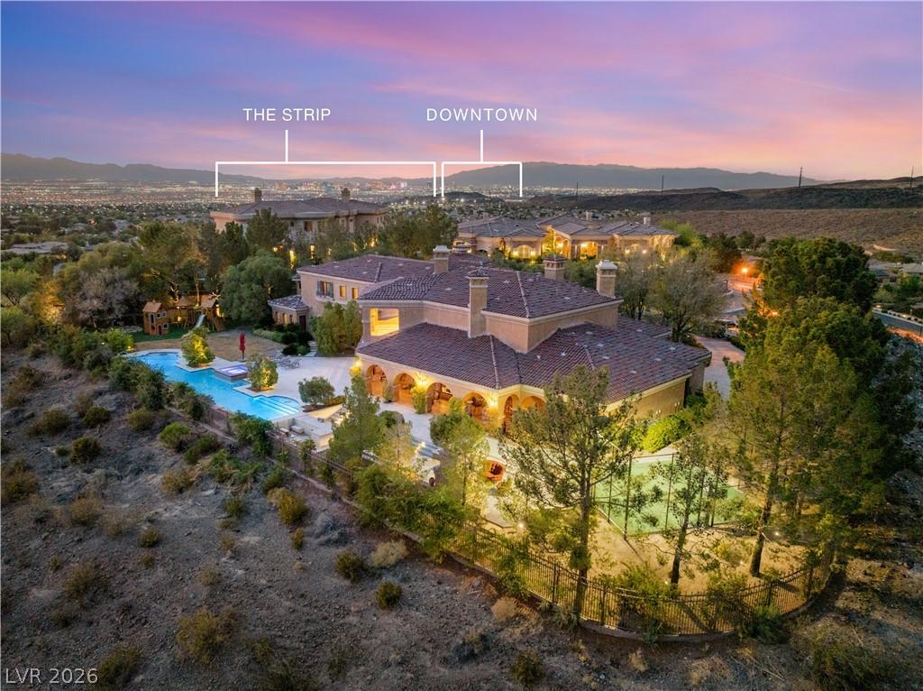 Image 1: City lights twinkle beyond this expansive estate,