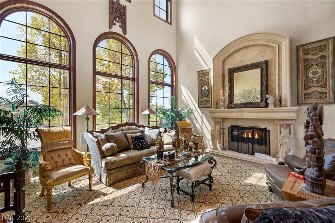 Image 3: Ornate fireplace and grand arched windows define t