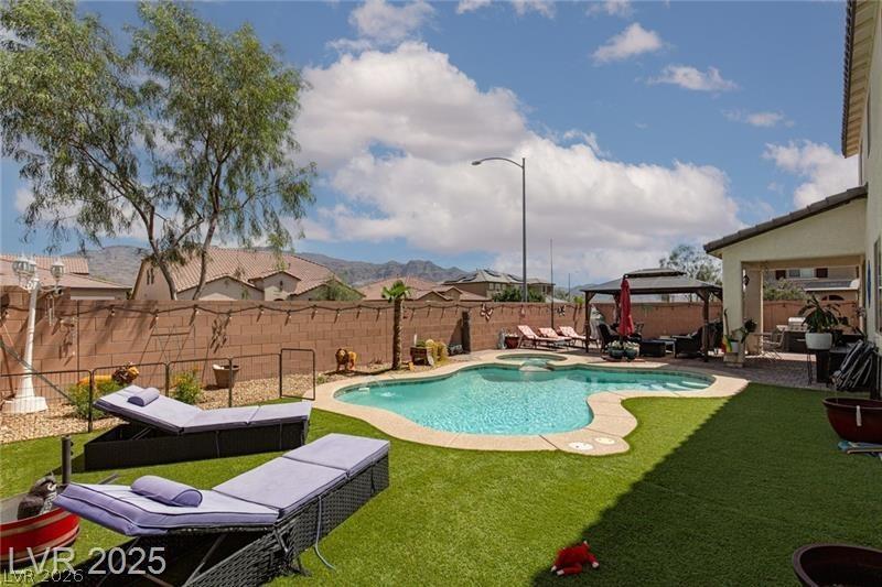 Image 1: This outdoor oasis offers a refreshing swimming po
