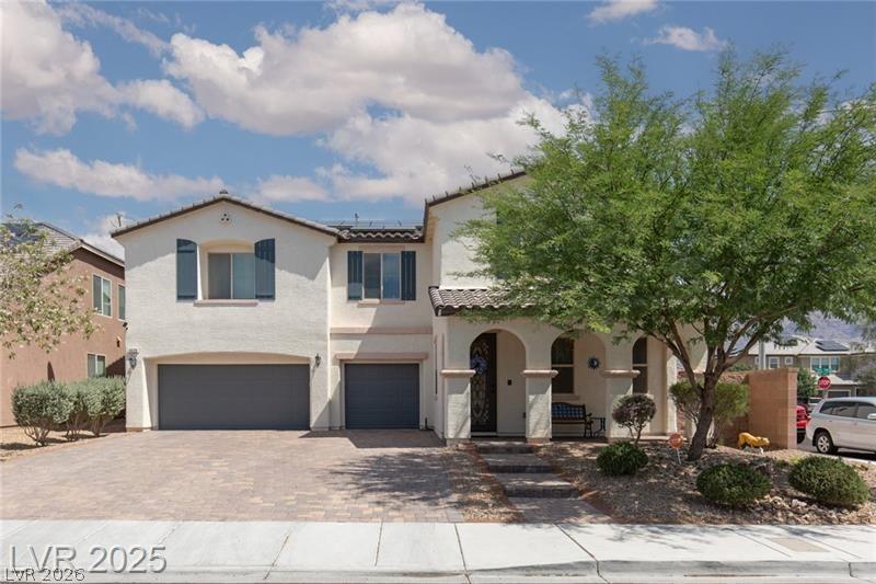 Image 2: This two-story home features a stucco exterior and