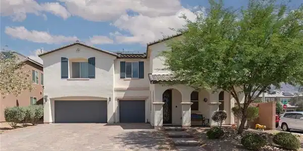 Image 2: This two-story home features a stucco exterior and