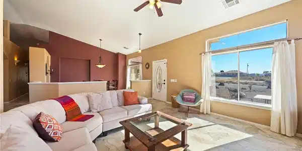 Image 2: This airy living space features abundant natural l