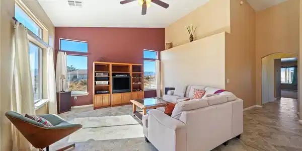 Image 4: This bright living space features tall ceilings an