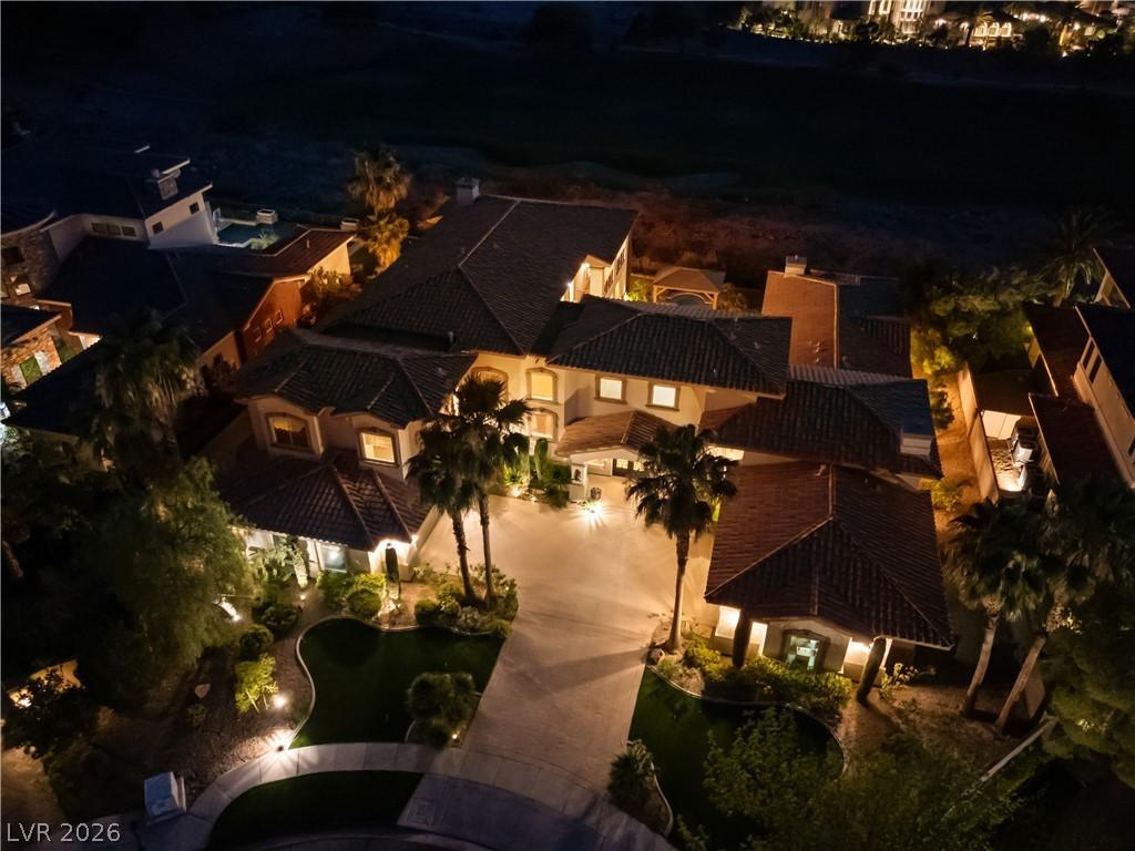 Image 2: An aerial nighttime perspective reveals a grand es