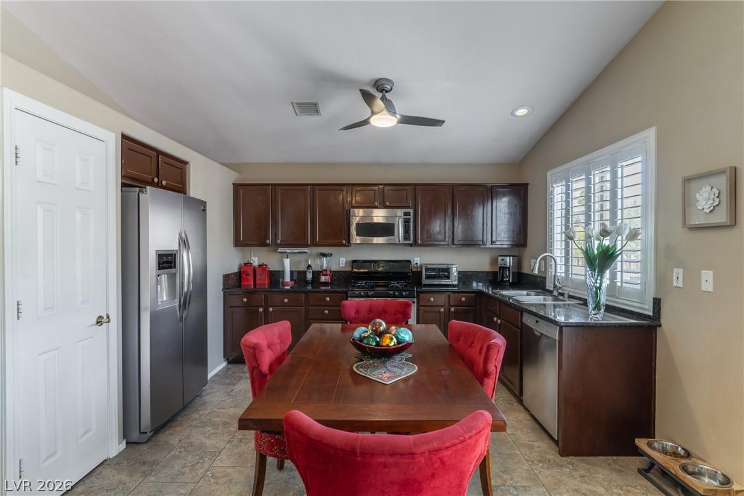 Image 4: Kitchen with granite countertops, dark cabinetry,