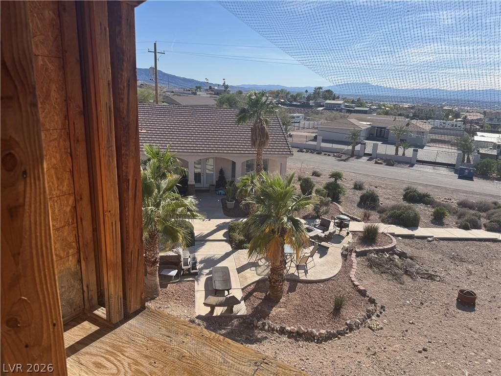 Image 3: A well-maintained outdoor patio area overlooks a n