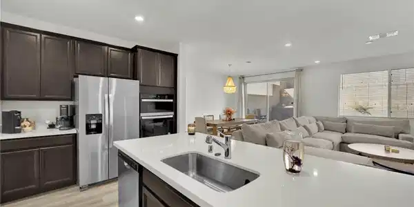 Image 2: An open floorplan seamlessly connects the modern k