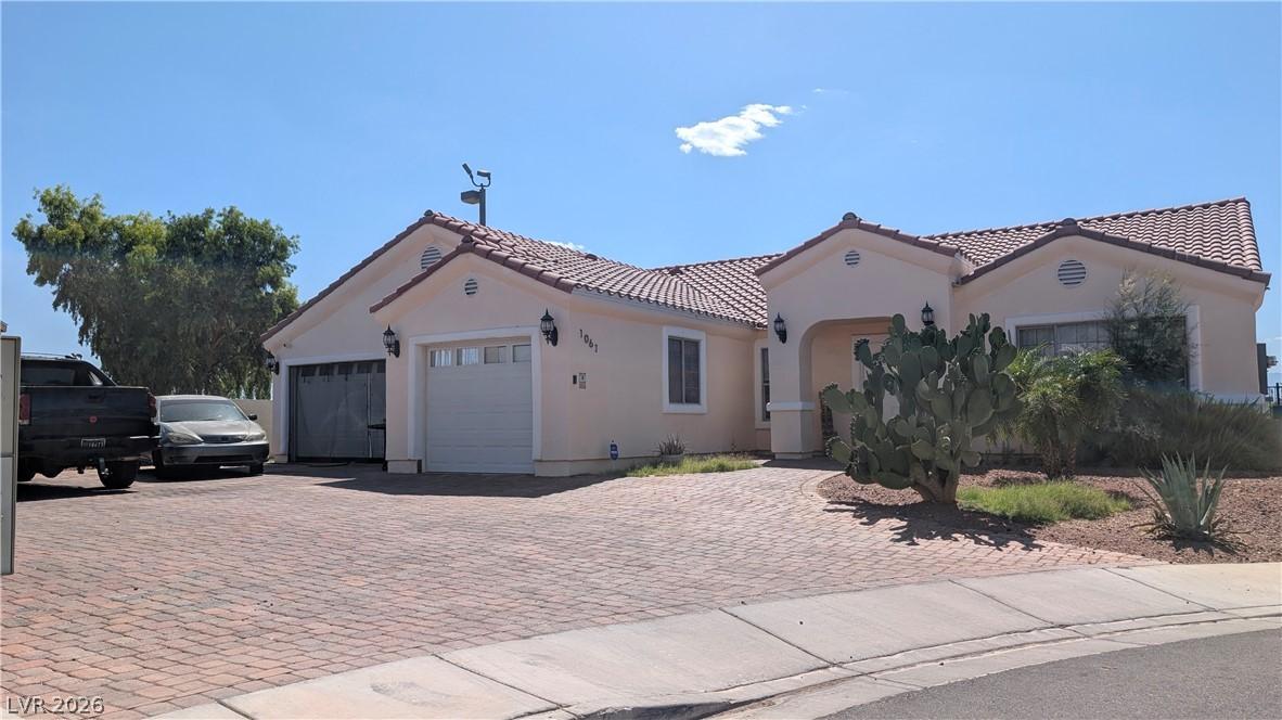 Image 2: A terracotta tile roof crowns this light-toned hom