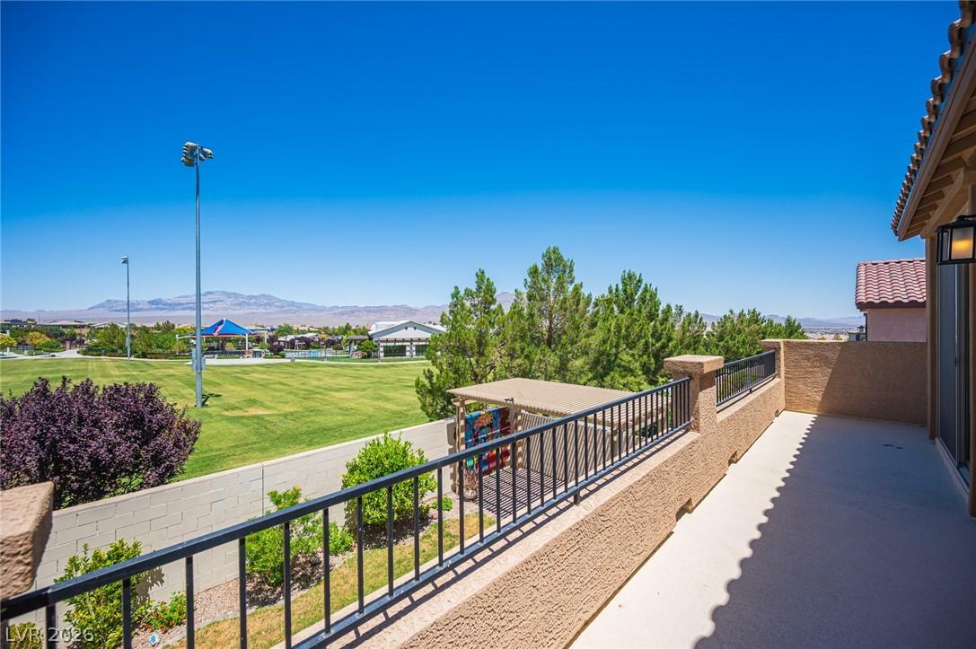 Image 2: A spacious terrace offers panoramic views of green
