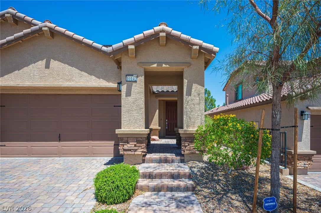 Image 3: A welcoming stone-clad entryway invites you into t