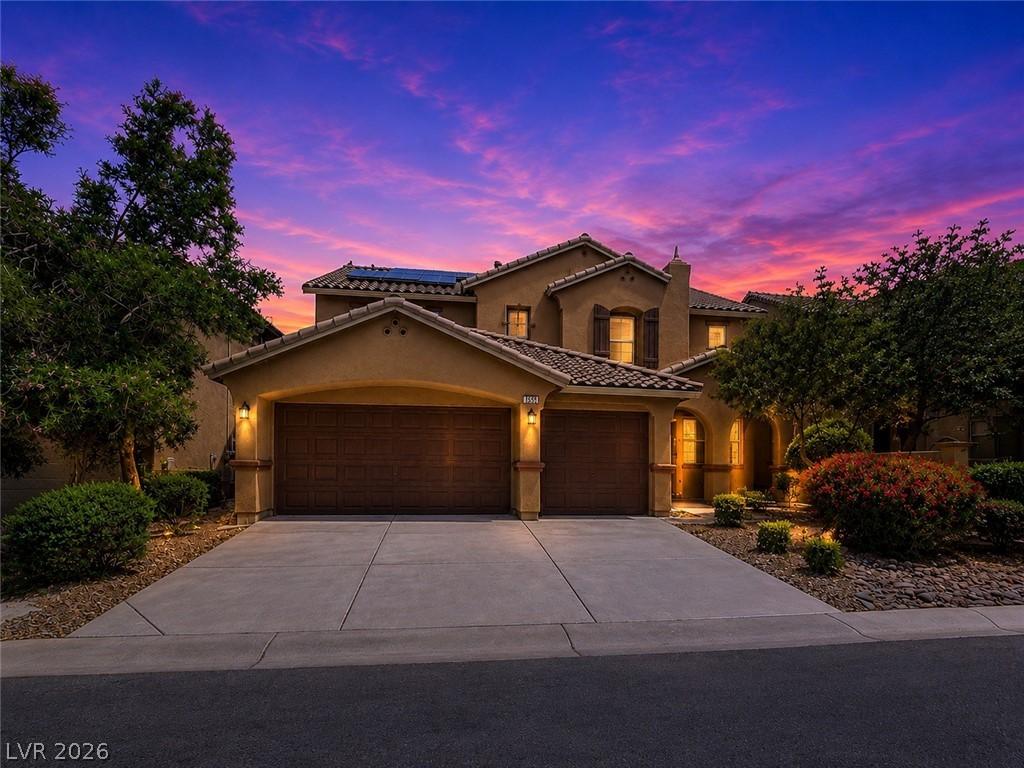 Image 1: This charming home offers curb appeal, two garages