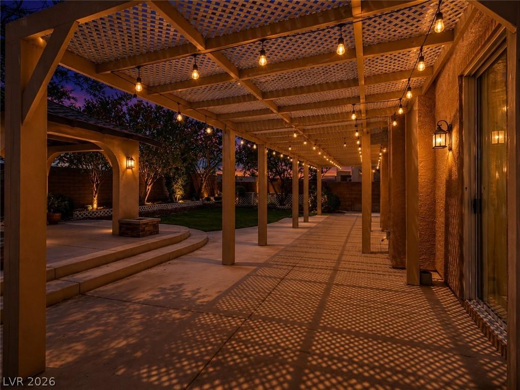 Image 3: This inviting patio features a charming pergola, p