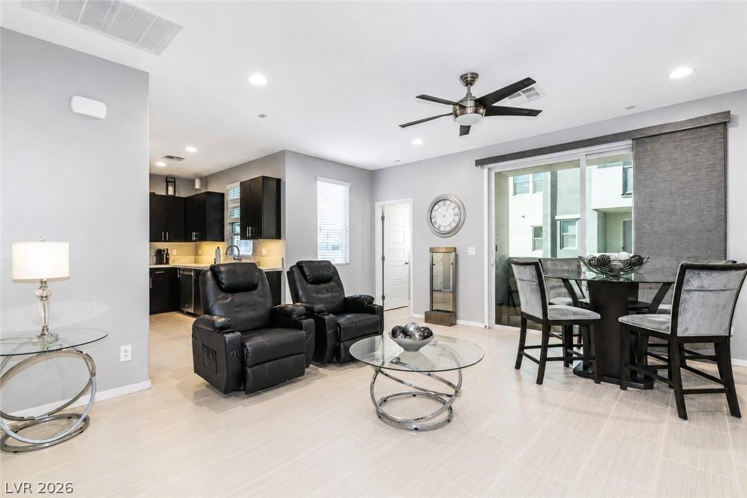 Image 4: An open concept living and dining area boasts clea