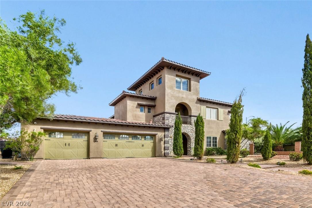 Image 2: Front of home, 3 car garage and block driveway
