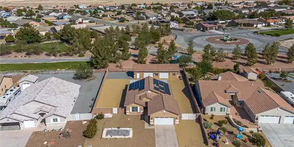 Image 2: Aerial perspective of suburban area featuring moun