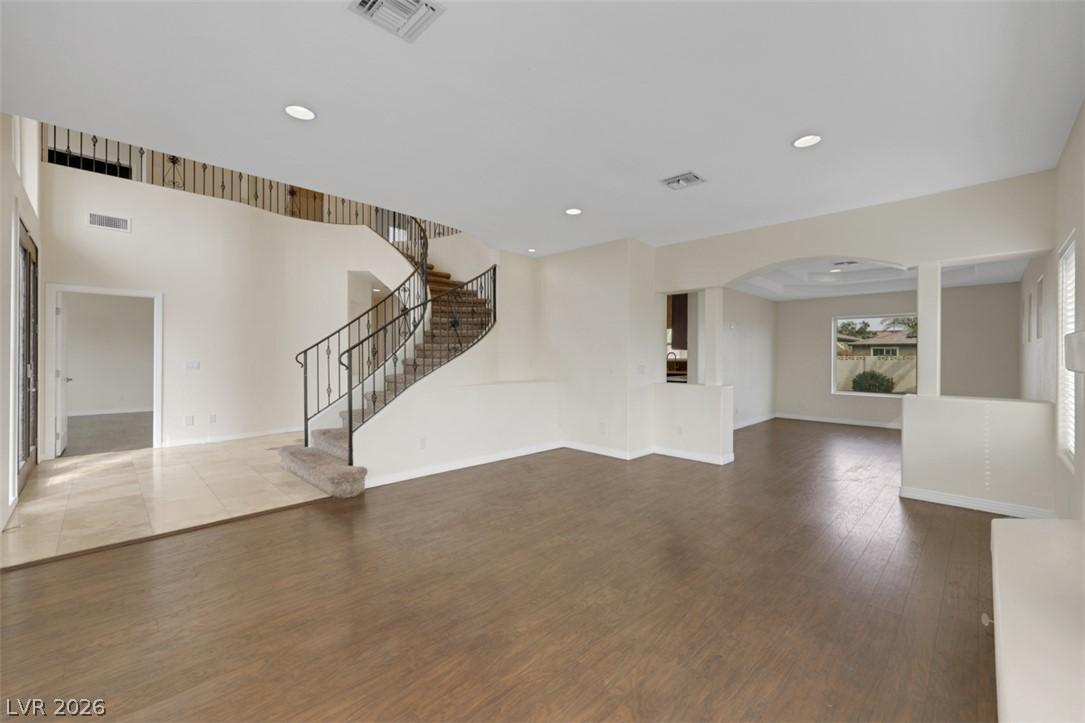 Image 4: A grand spiral staircase welcomes you into this ho