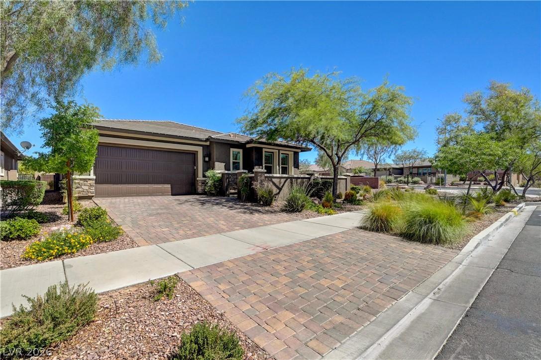 Image 3: A neatly paved driveway leads to this charming hom
