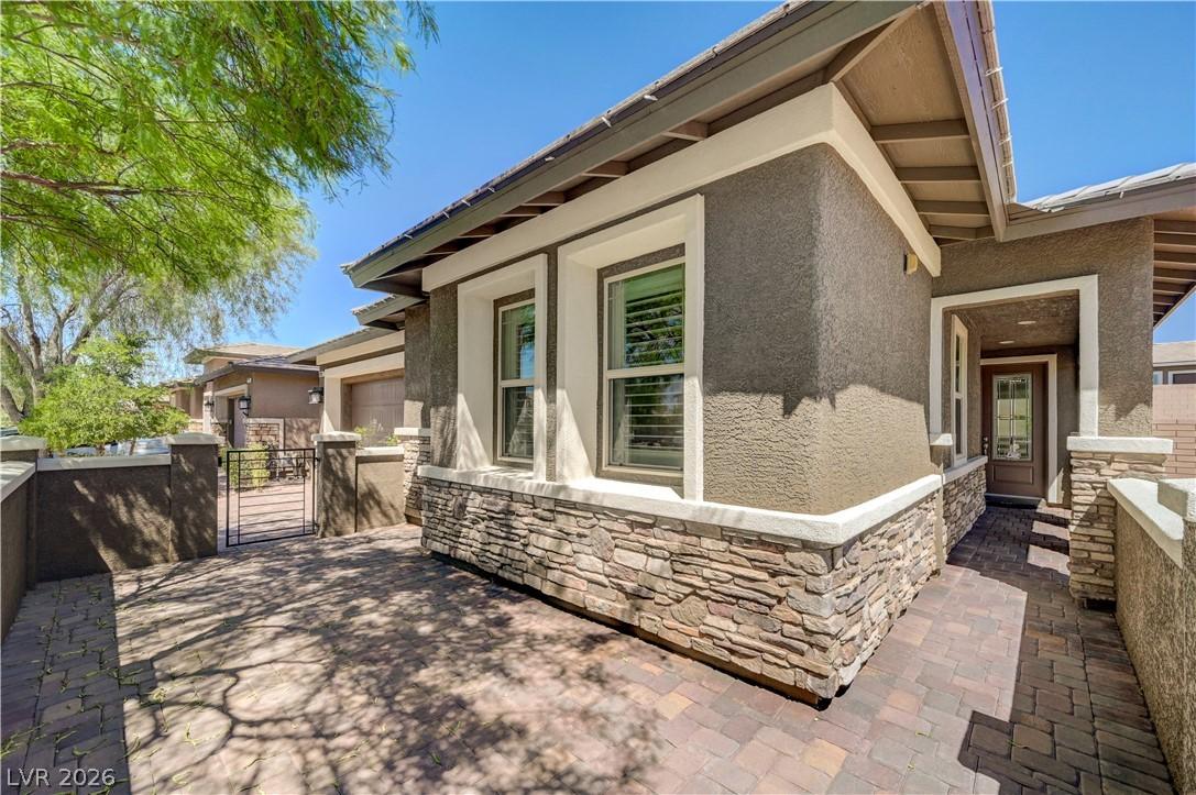 Image 4: A welcoming entry path features pavers and elegant