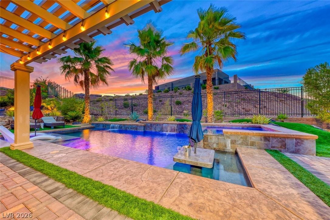 Image 1: An inviting backyard oasis offers a sparkling pool