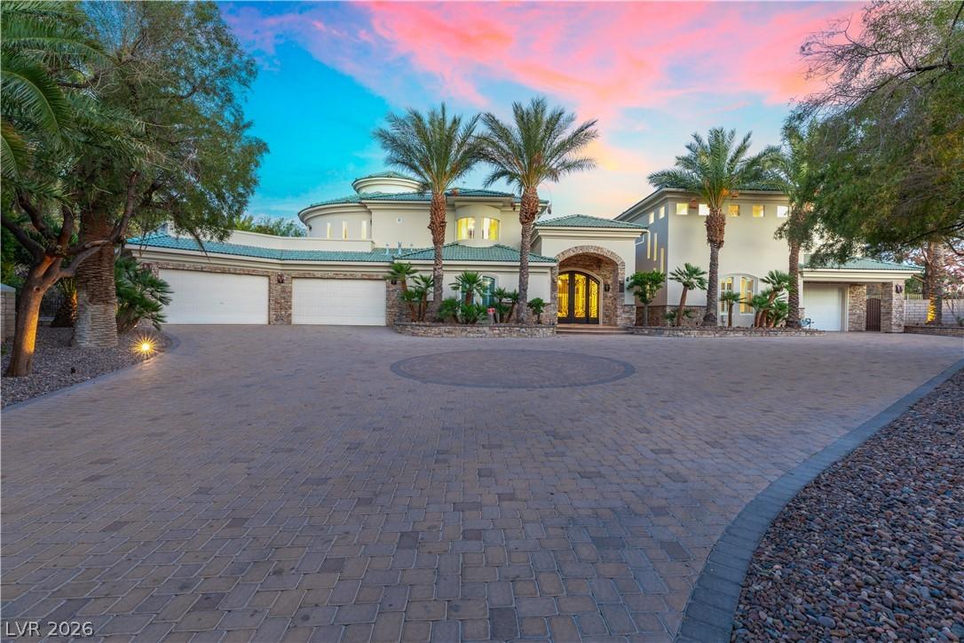 Image 2: An impressive paver driveway leads to a grand entr