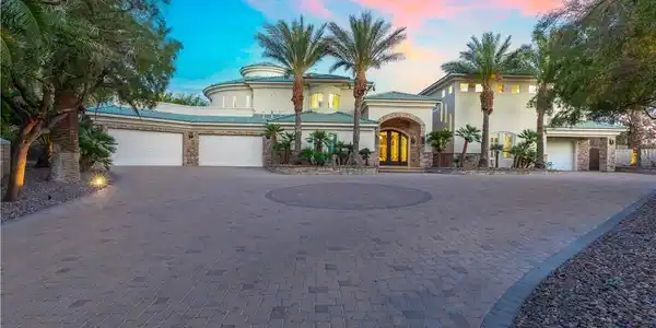 Image 2: An impressive paver driveway leads to a grand entr