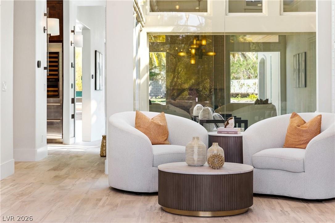 Image 4: A welcoming sitting area with wood flooring flows
