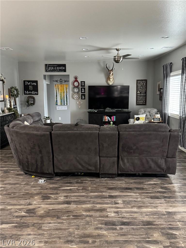 Image 3: Living area with dark wood finished floors and cei