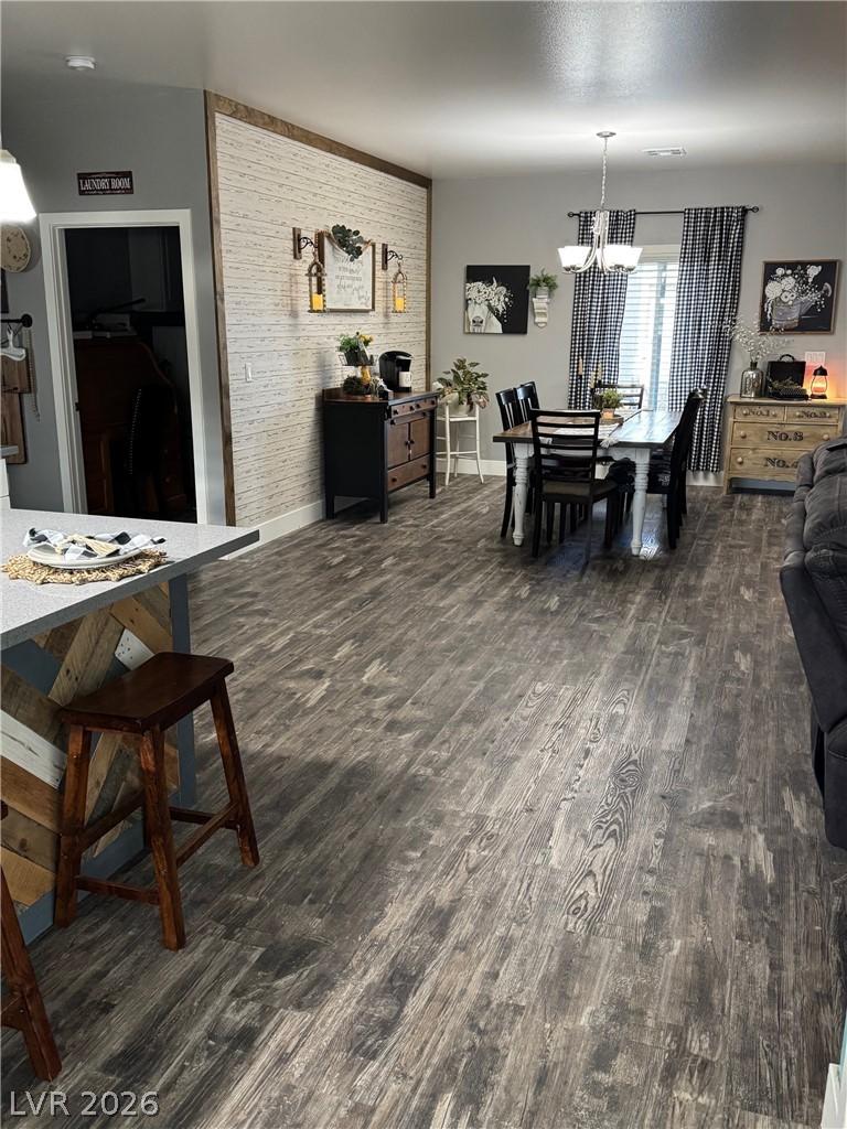 Image 4: Dining room with dark wood-style flooring and bric