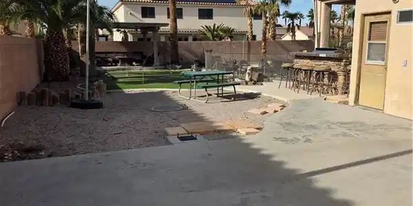 Image 2: Fenced backyard with a patio