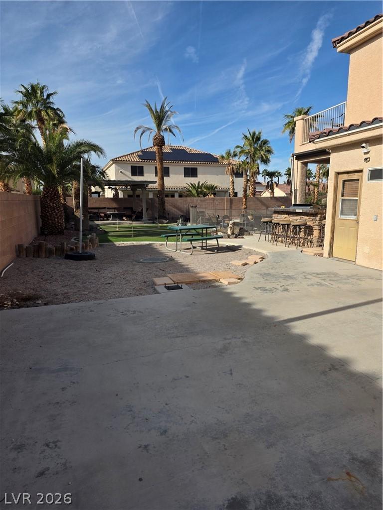 Image 3: Fenced backyard with a patio