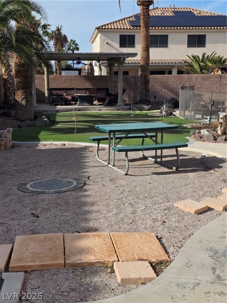 Image 4: Surrounding community with a pergola, a fenced bac