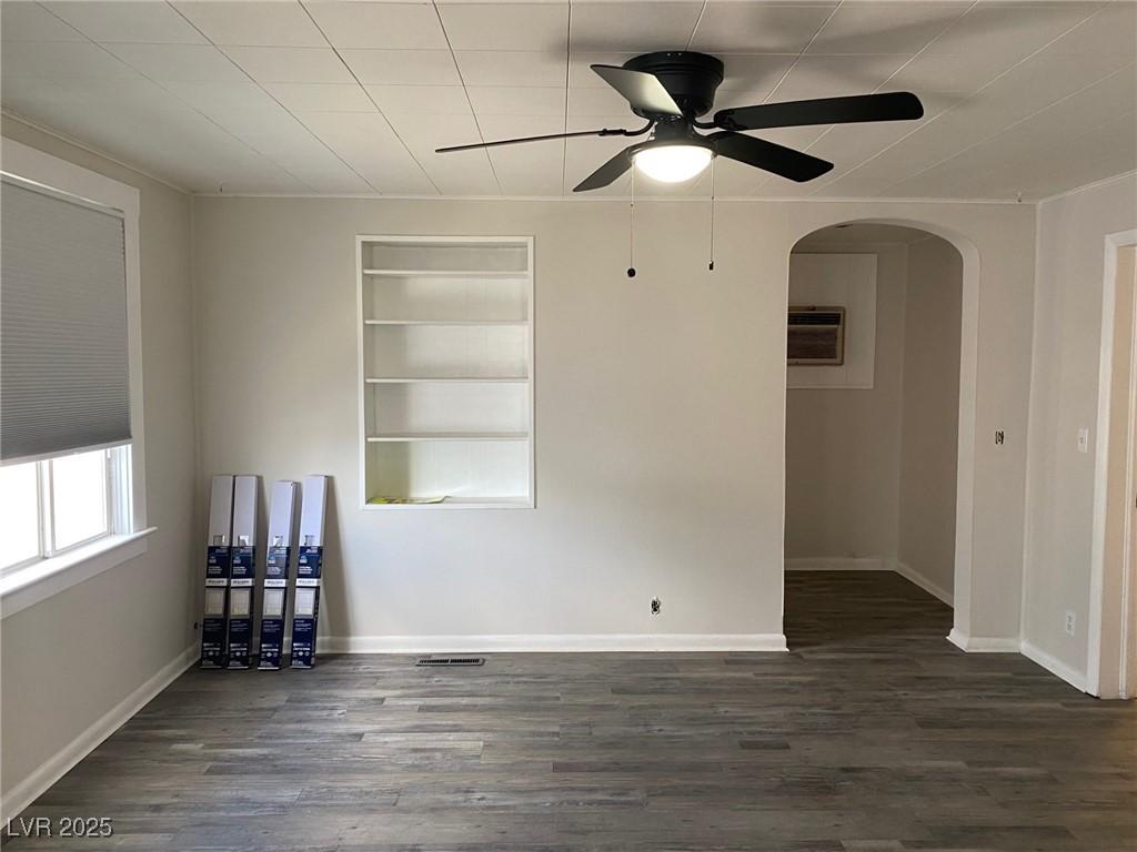 Image 4: Empty room with built in shelves, dark wood-style