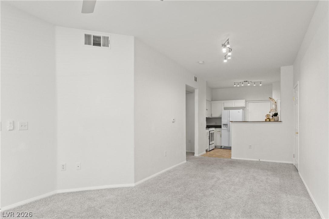 Image 3: A well-lit living area flows seamlessly into the k