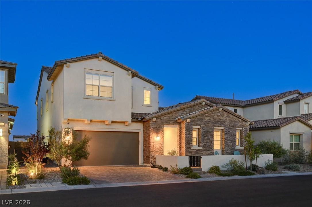 Image 3: Crafted with stucco and stone, this elegant home p