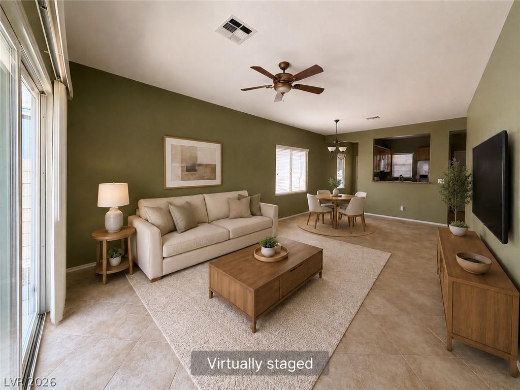 Image 1: Natural light floods this living area, offering co