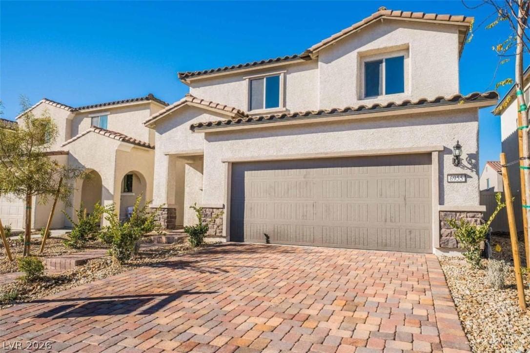 Image 2: A grand exterior showcases stucco, stone accents,
