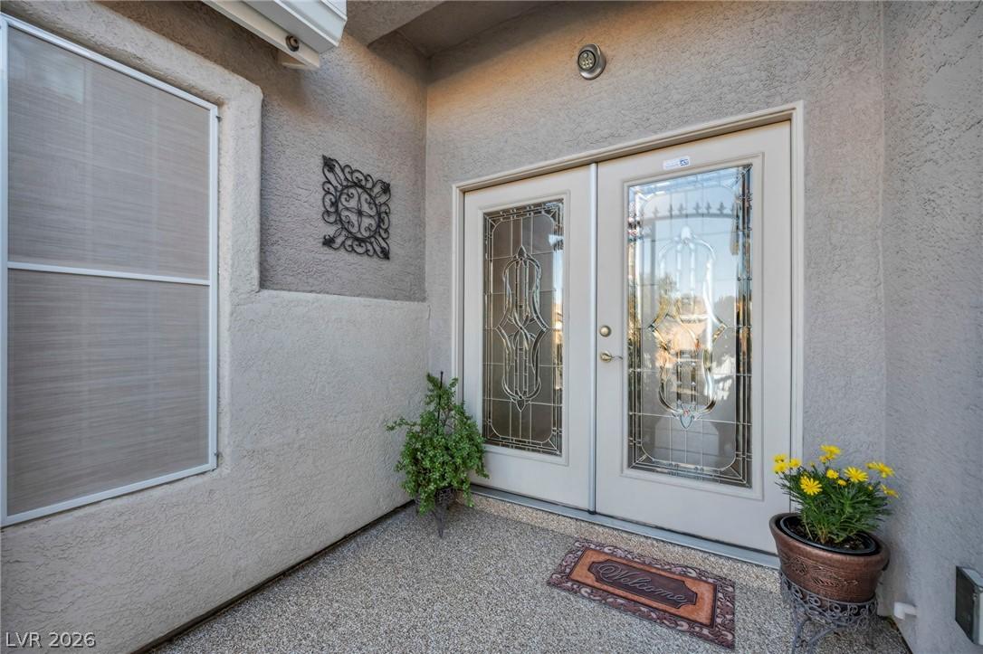 Image 2: This inviting entrance features dual doors with de