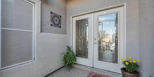 Image 2: This inviting entrance features dual doors with de
