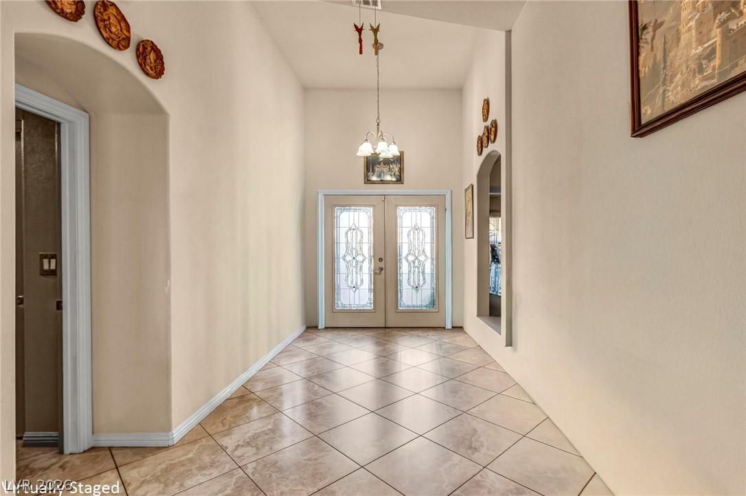 Image 3: Elegant entry with ornate double doors and a polis