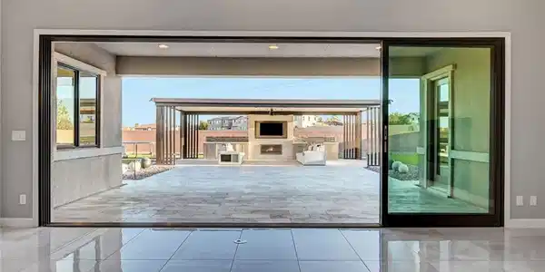 Image 4: Massive sliding glass doors bridge the indoor livi