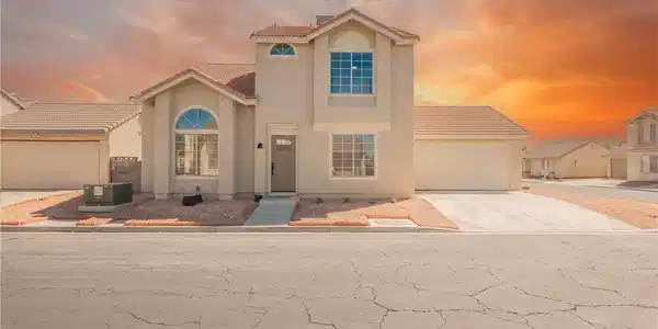 Image 2: Two-story stucco architecture featuring clean line