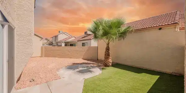Image 3: A private concrete patio leads to low-maintenance