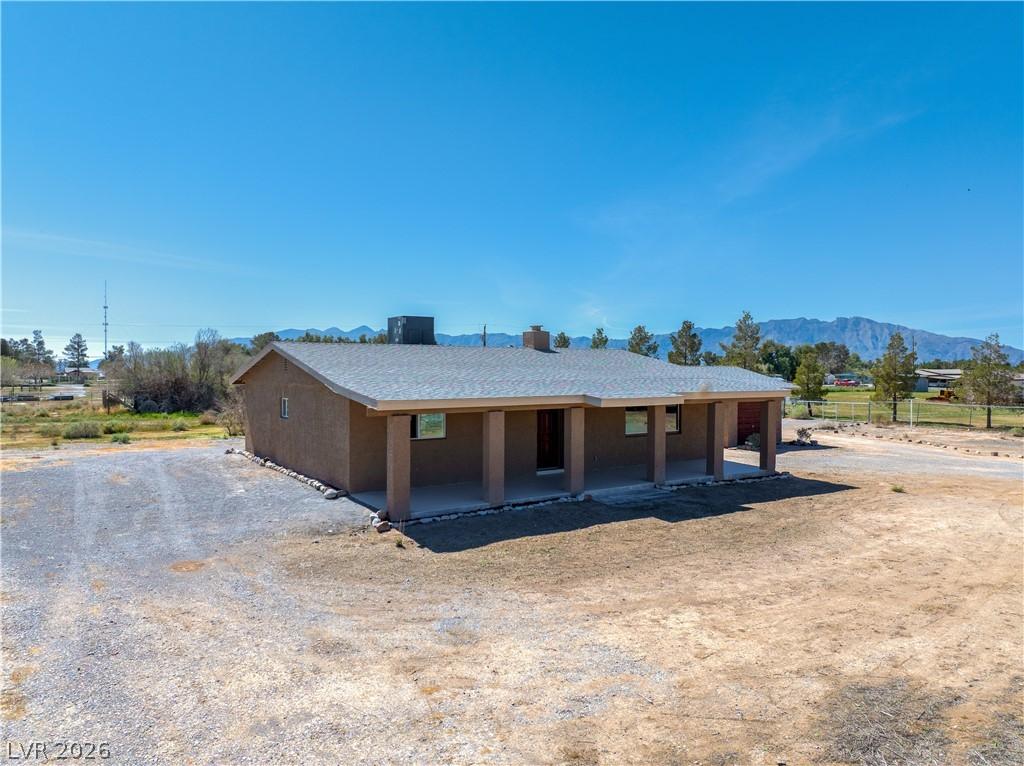 Image 3: Back of property with a mountain view and a chimne