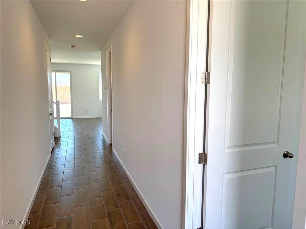 Image 3: Corridor with recessed lighting and wood tiled flo