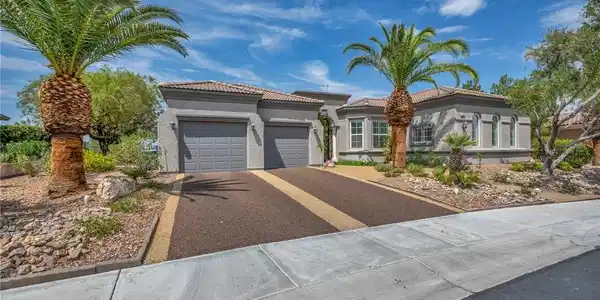 Image 3: Mature palm trees adorn the entry to this graceful