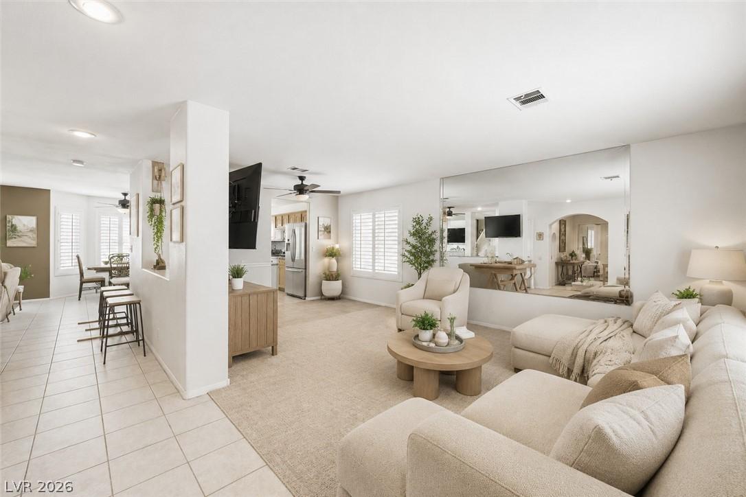 Image 3: An inviting open-concept living area boasts light-