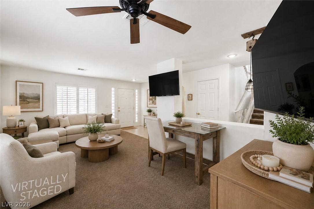 Image 4: A versatile living space with a ceiling fan, plush