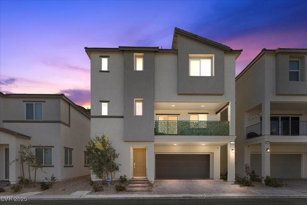 Image 1: View of front of property with a balcony, stucco s